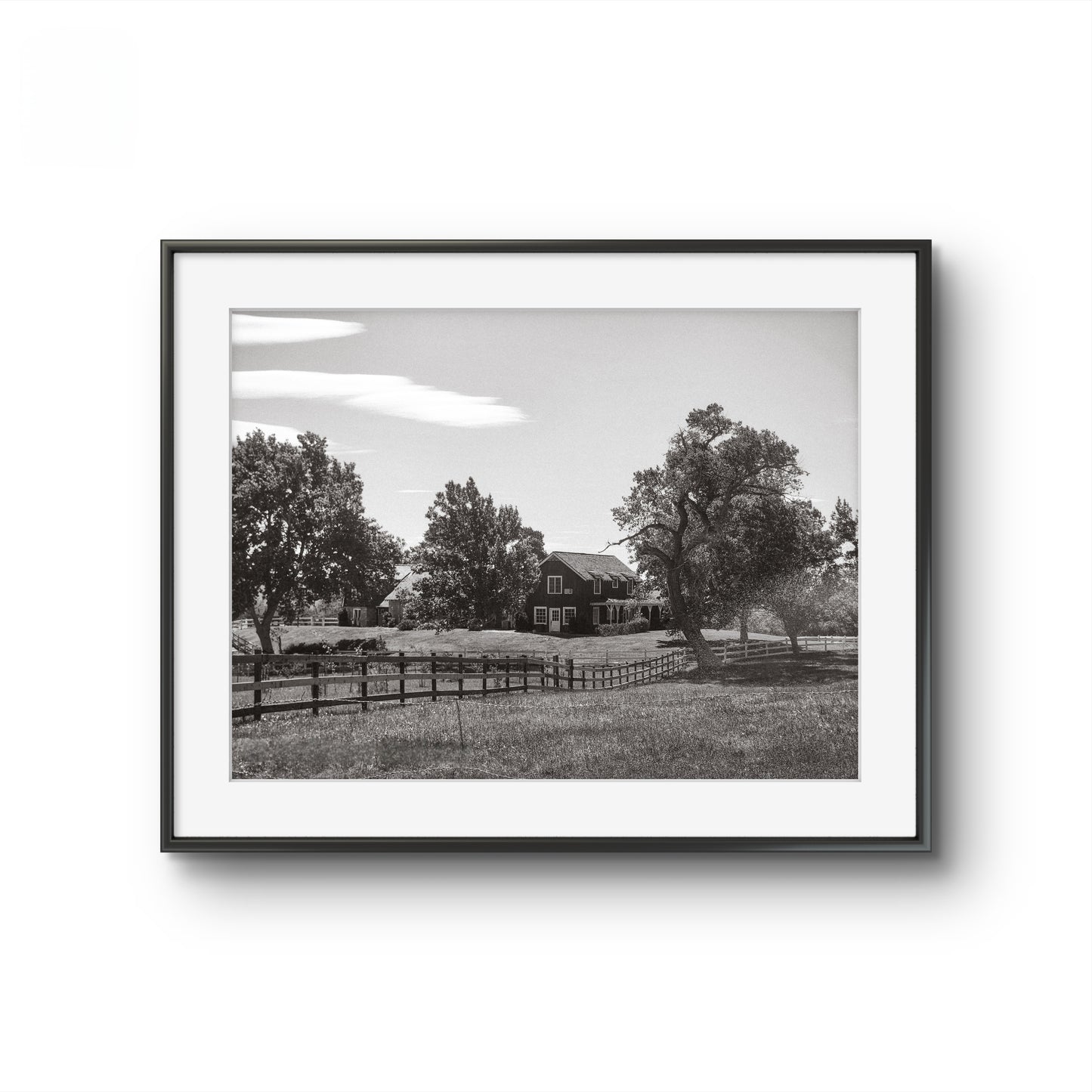 Framed black and white photo of a house on a prairie